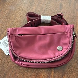 New with tags, LULULEMON all night festival bag. Beautiful wine berry color 2L
